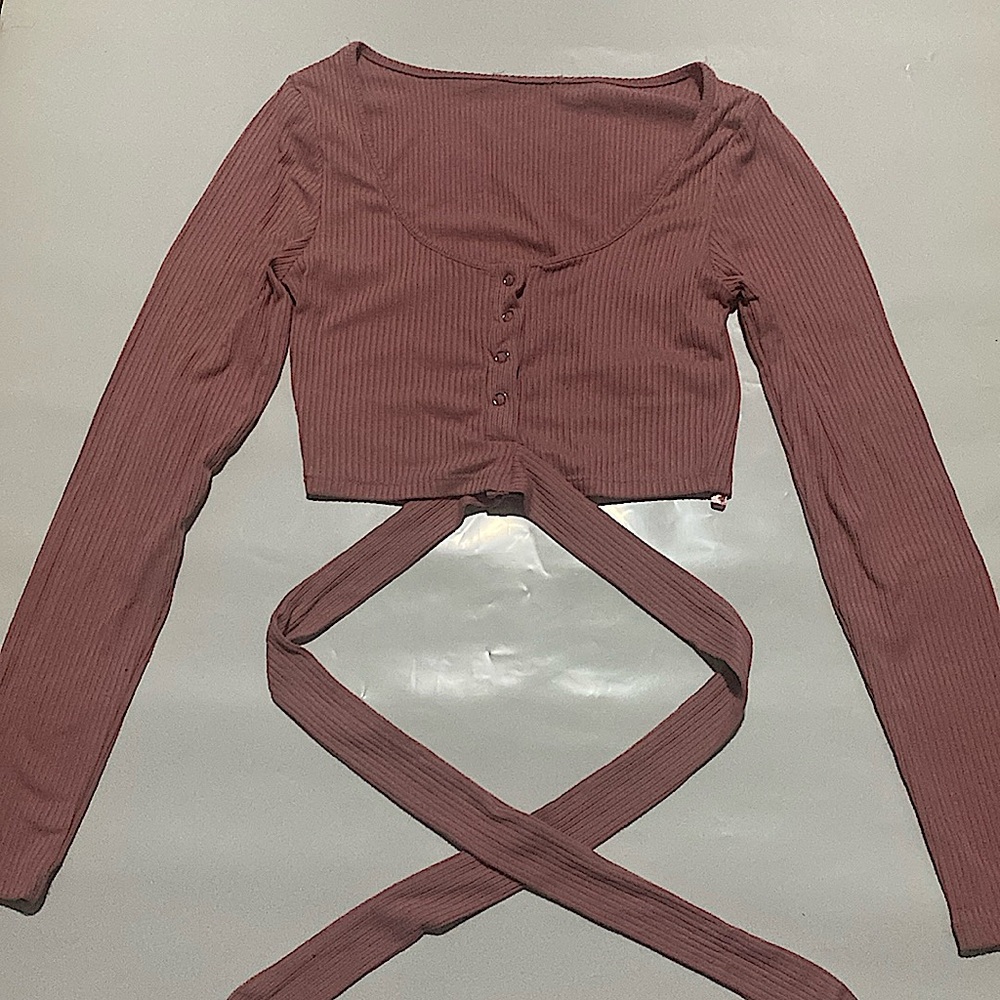 Pink cropped long sleeve with straps.